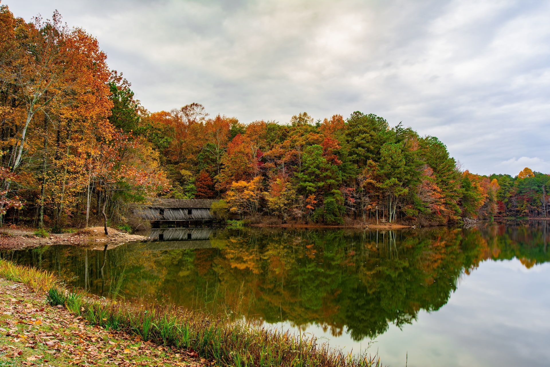 A man , woman and child are hugging each other and smiling.