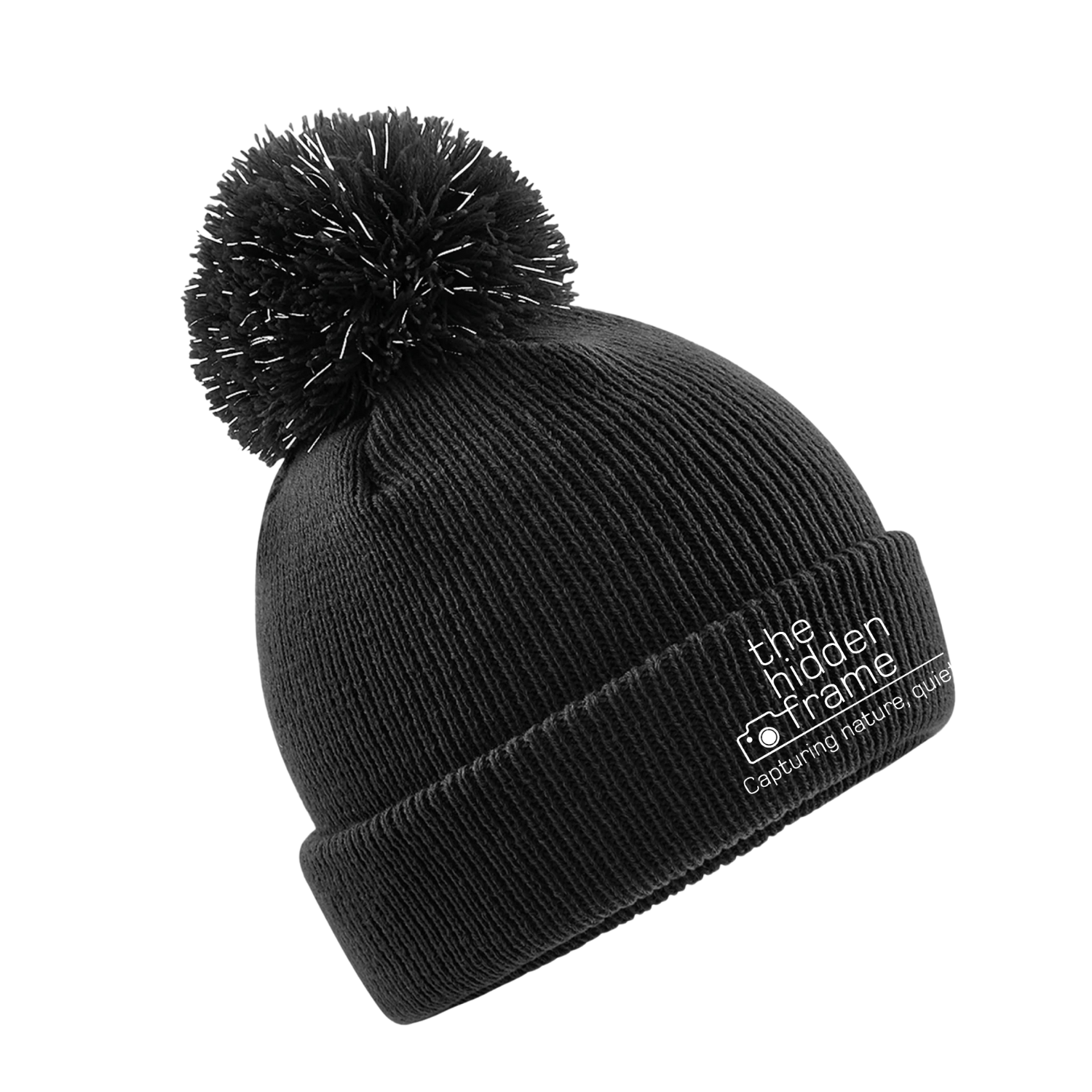 Black knit beanie with a pom-pom, the words 