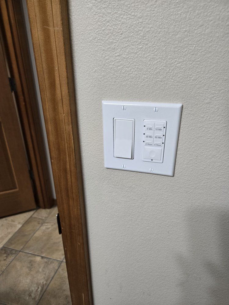 A white light switch is mounted on a wall next to a door.