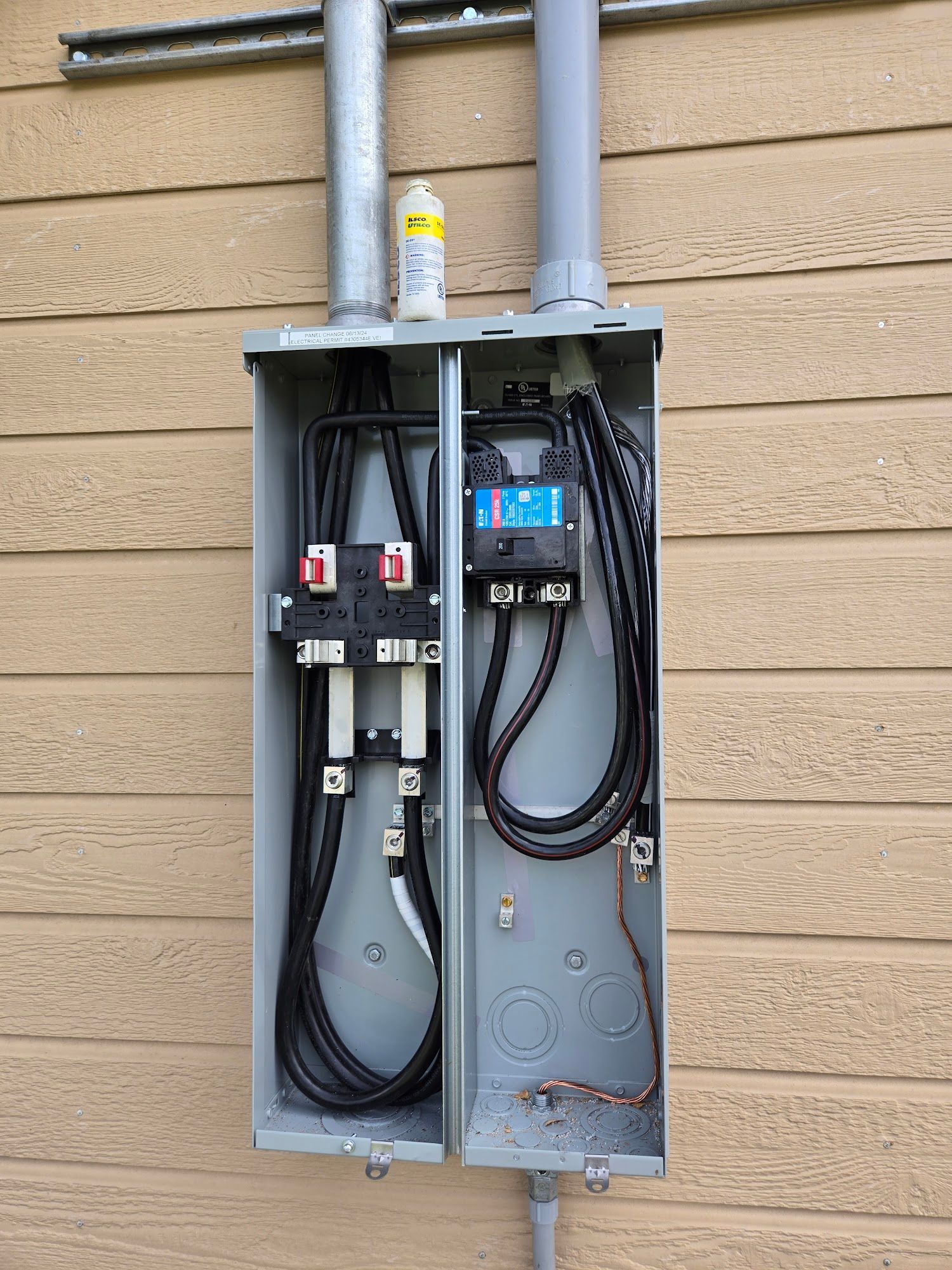 A close up of an electrical box on the side of a building.