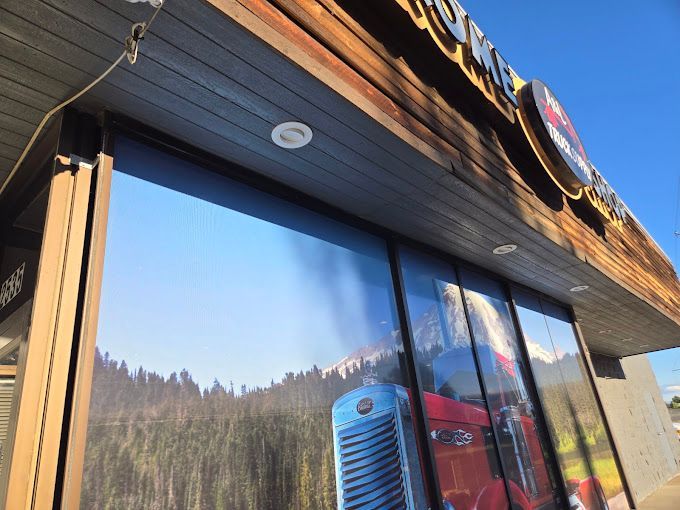 An empty room with a ceiling fan and a window.