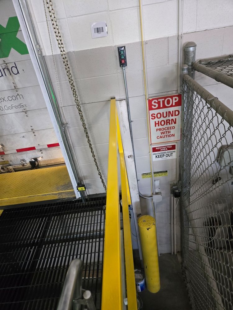 A sign on a wall that says stop sound horn