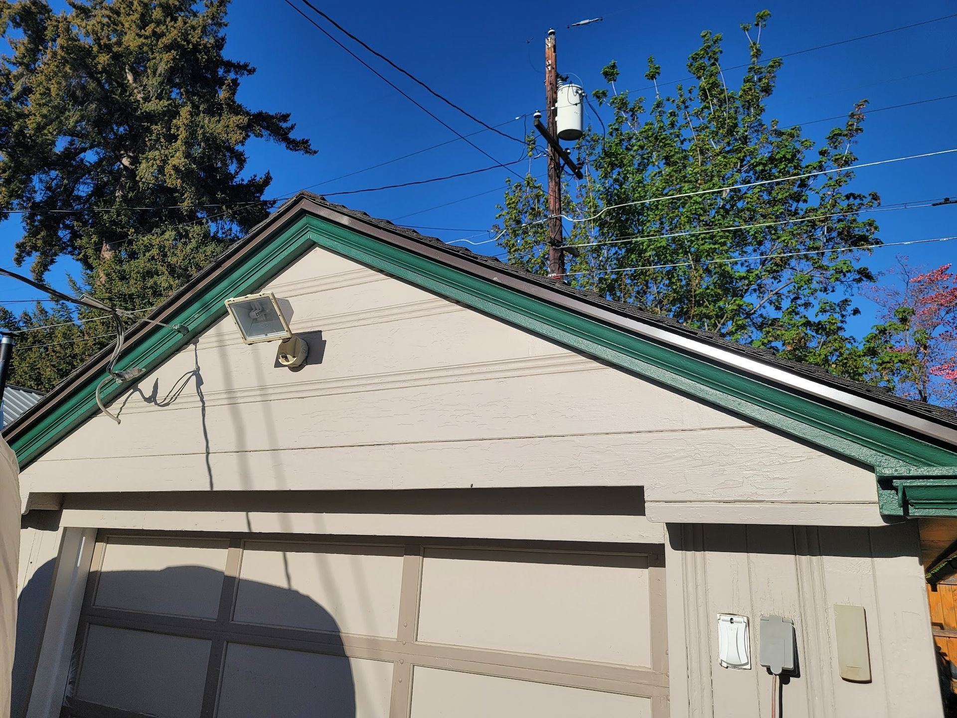 A house with a green roof and a satellite dish on it