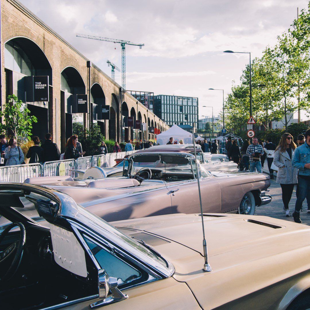 A line of classic cars in Kings Cross, London for The Classic Car Boot Sale