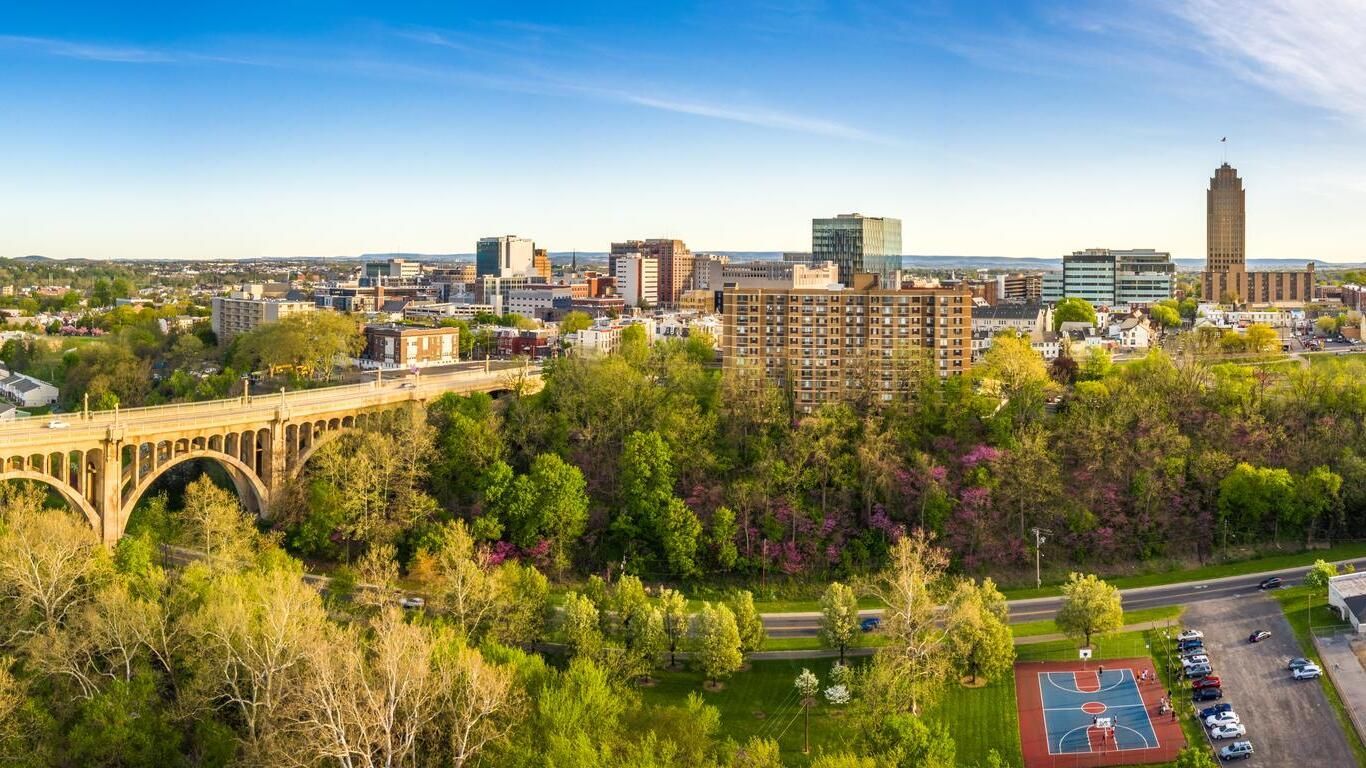 The Hartford, CT skyline is reflected in a body of water.