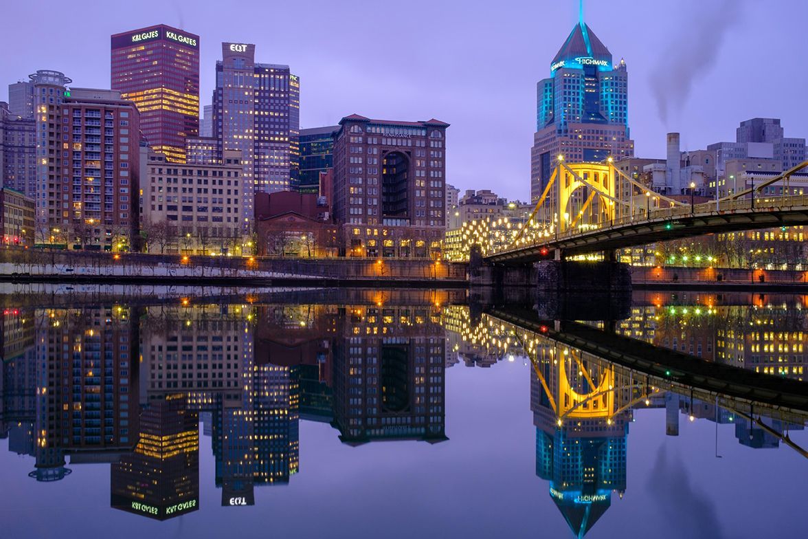 An aerial view of the Hartford, CT skyline at sunset with a parking lot in the foreground.