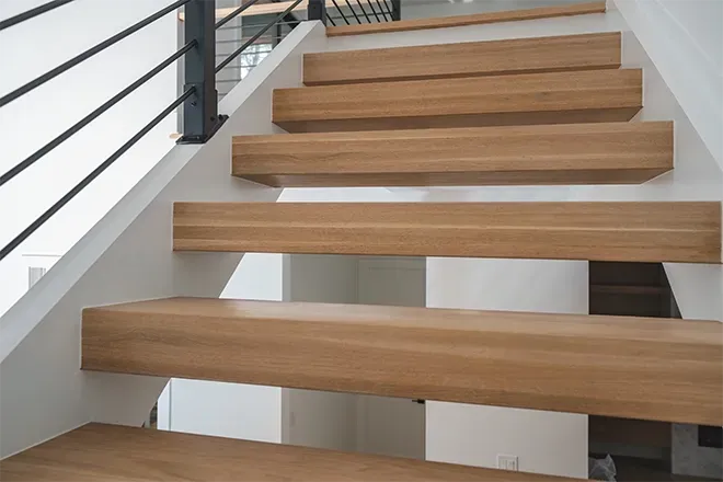 Freshly installed, gleaming hardwood floor in a well-lit room.