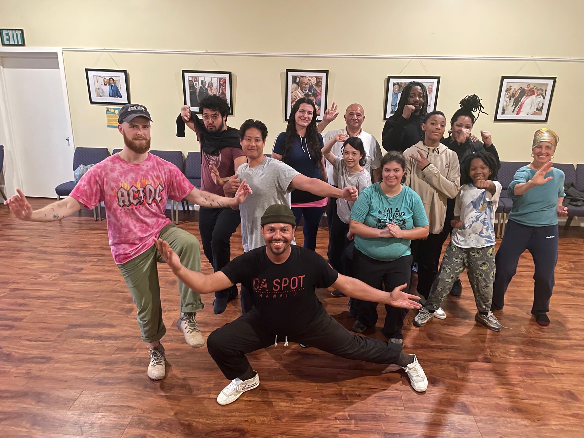 A group of people are posing for a picture in a Qigong studio.