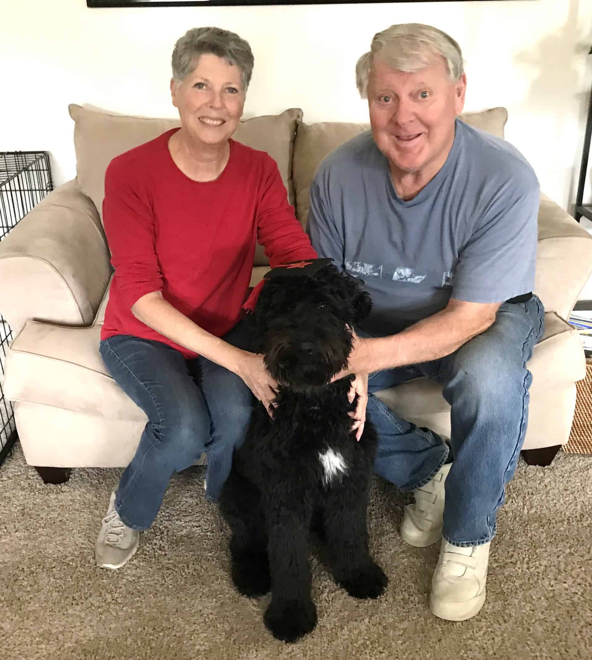 Black Cute Dog And Family — Saint Charles, MO — Positive Paws Pet Training Inc.