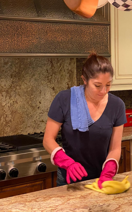 A mop and bucket on a tiled floor next to a window