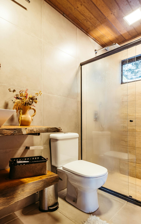 A living room with a white couch and a black rug.