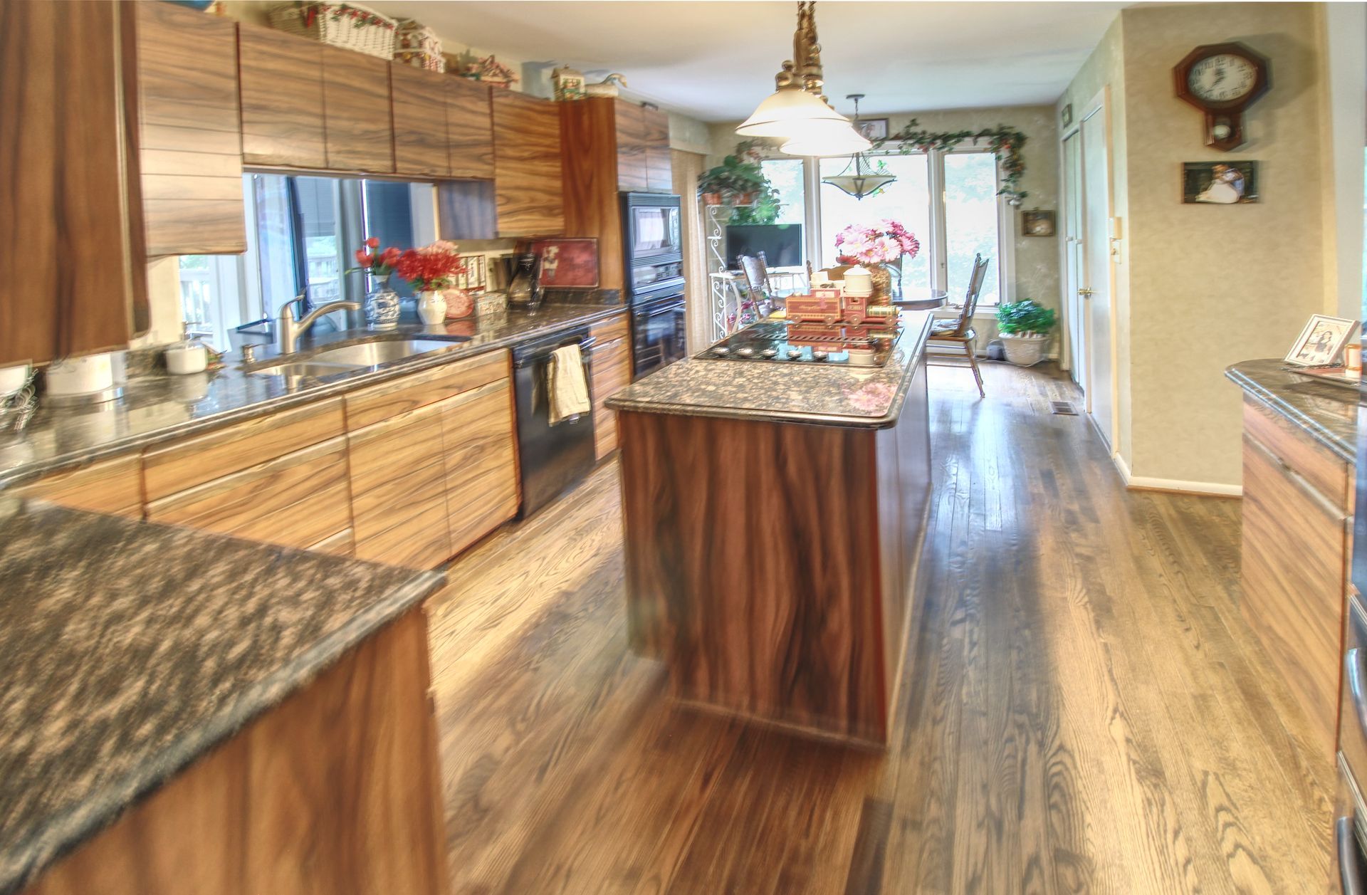 A kitchen with wooden cabinets and granite counter tops