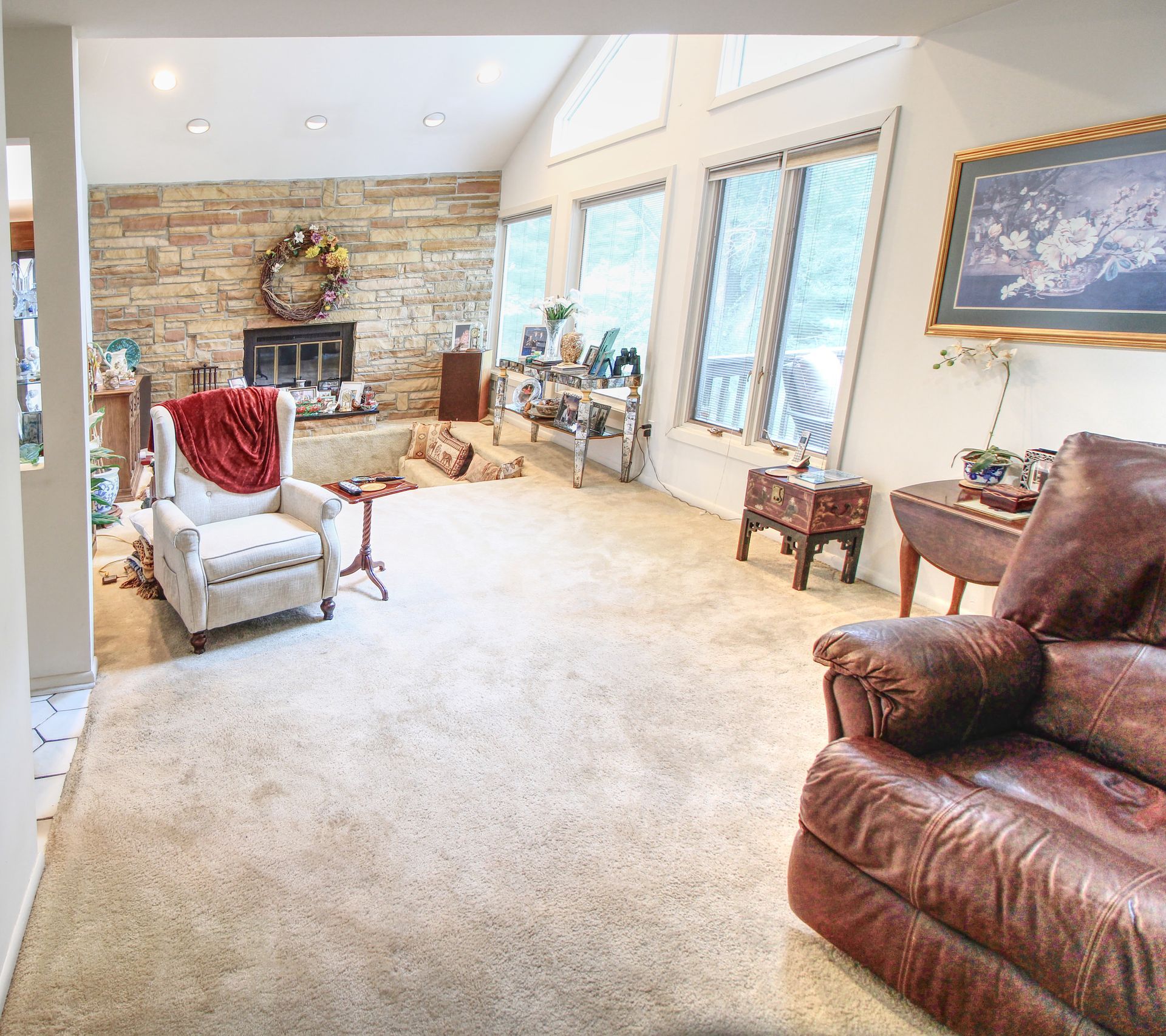 A living room with a couch a chair and a fireplace