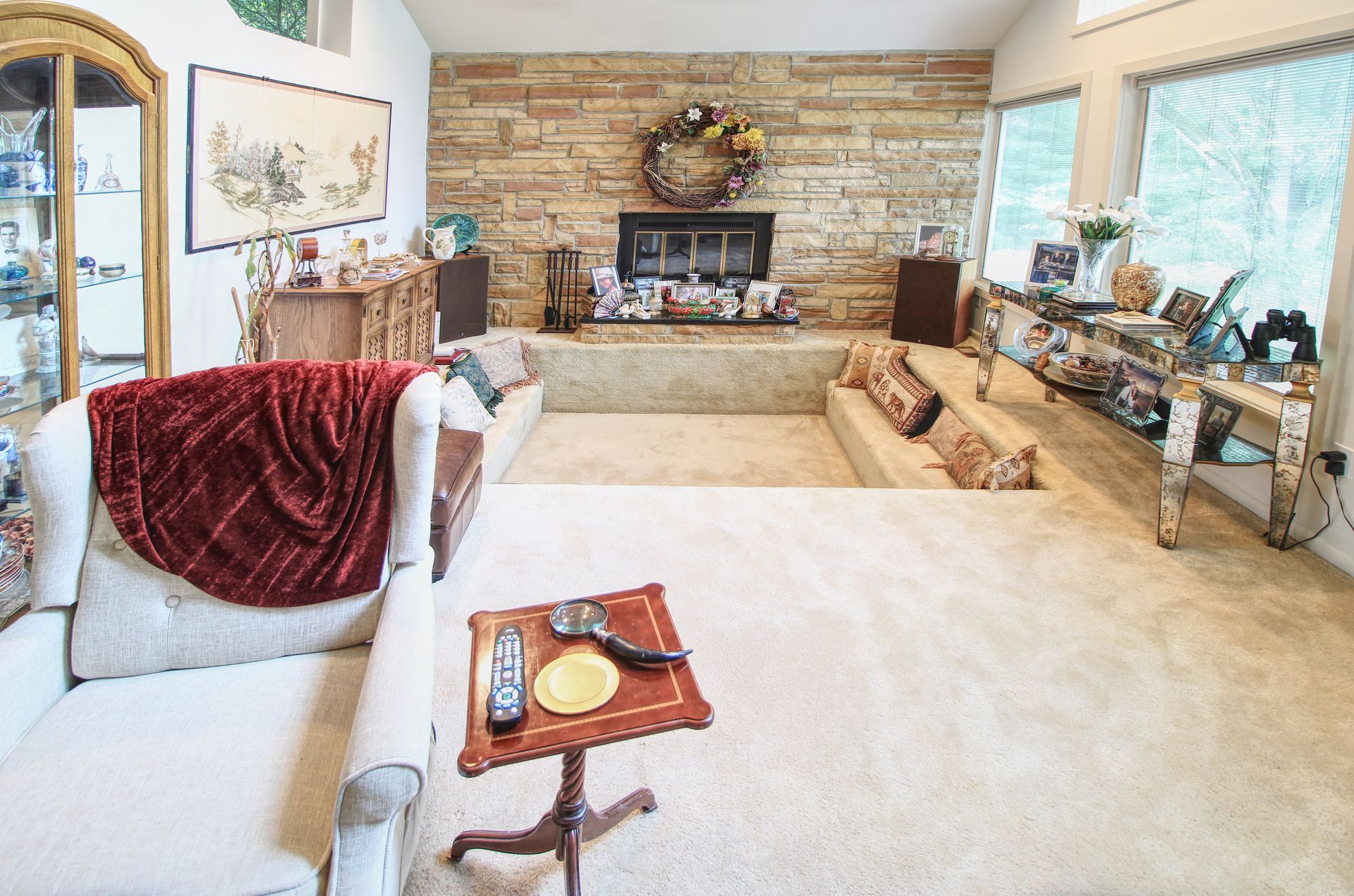 There is a fireplace in the middle of the living room.