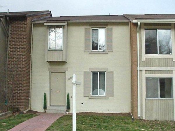 A house with a lot of windows and a brick chimney
