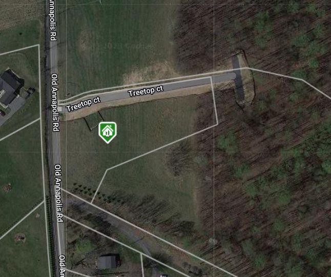 An aerial view of a residential area with a green circle in the middle.