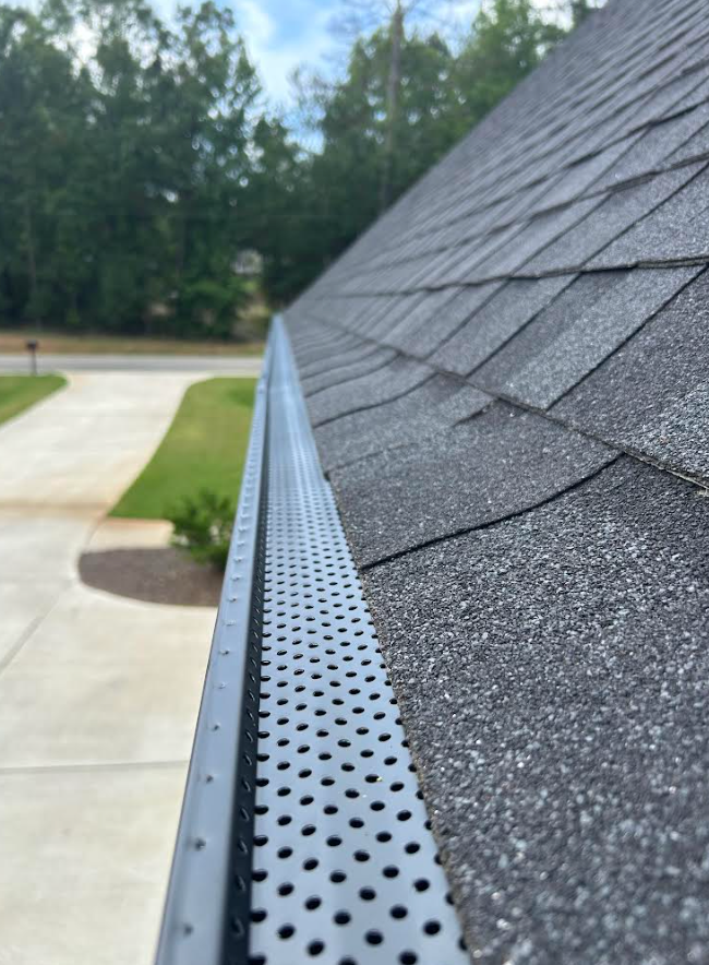 A close up of a gutter on the roof of a house.