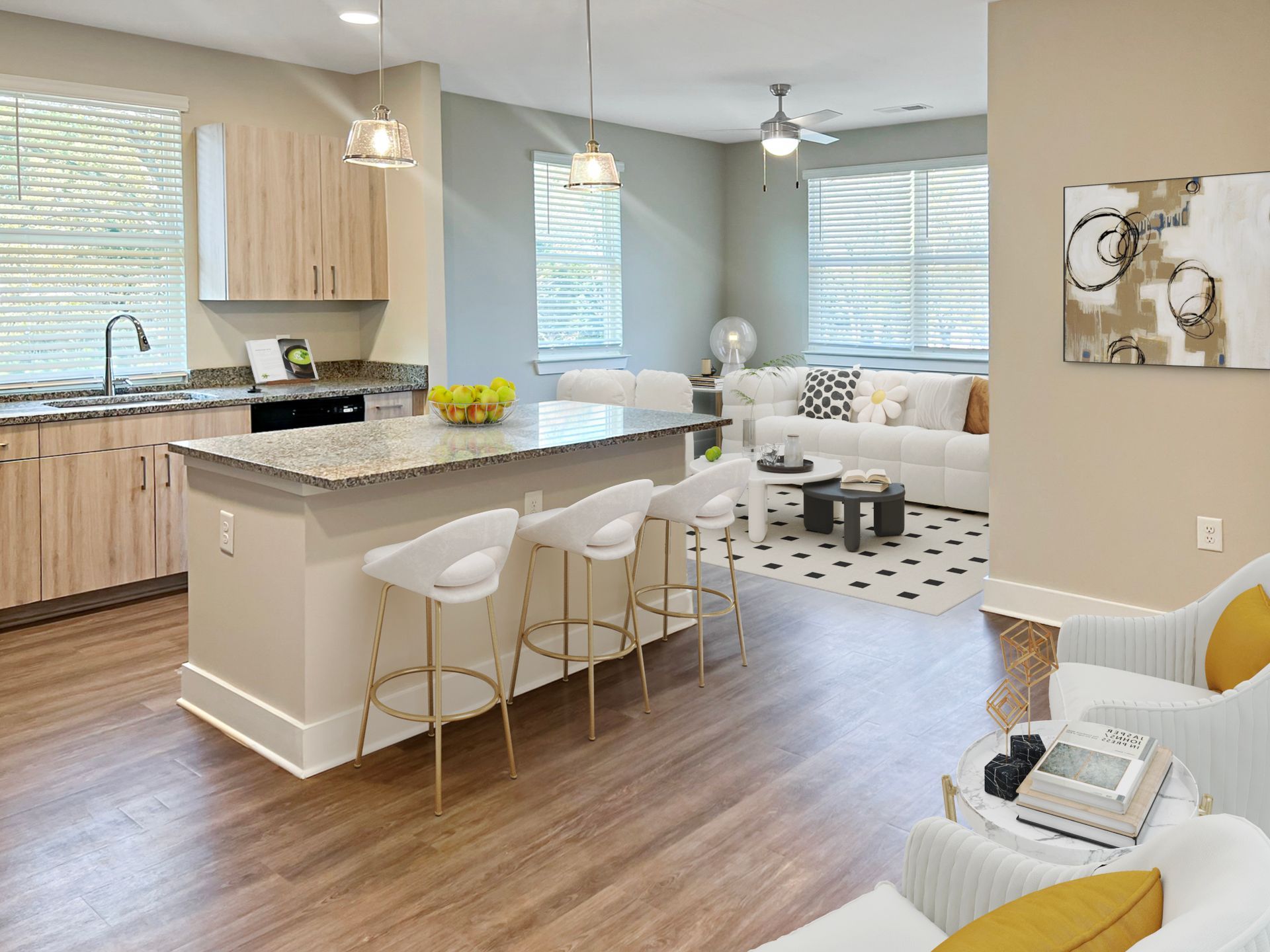 Open-concept kitchen and living area with granite island, bar stools, and white seating.