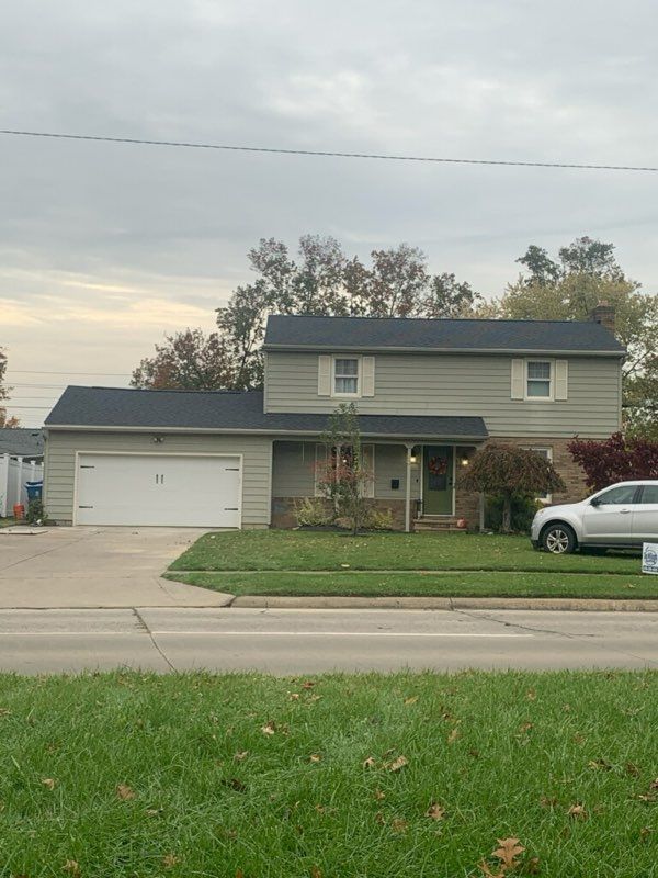 A house with a car parked in front of it