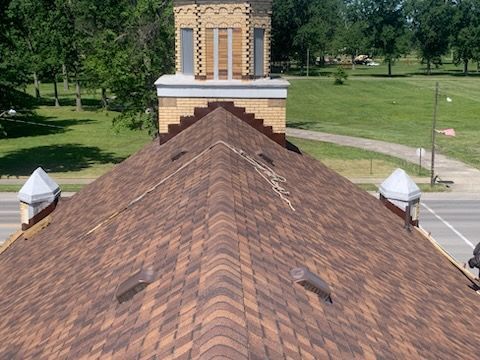 A brown roof with a chimney on top of it