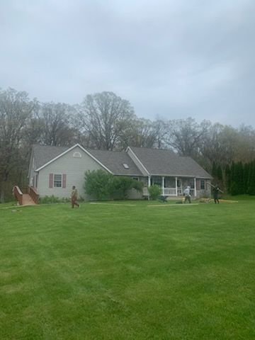 A house with a large lawn in front of it.