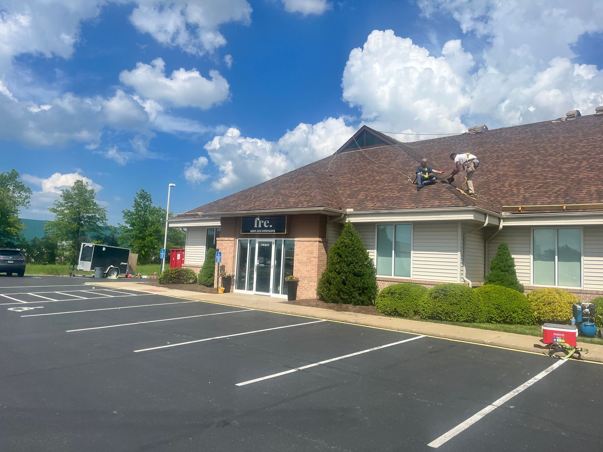 A roofer is working on the roof of a building.