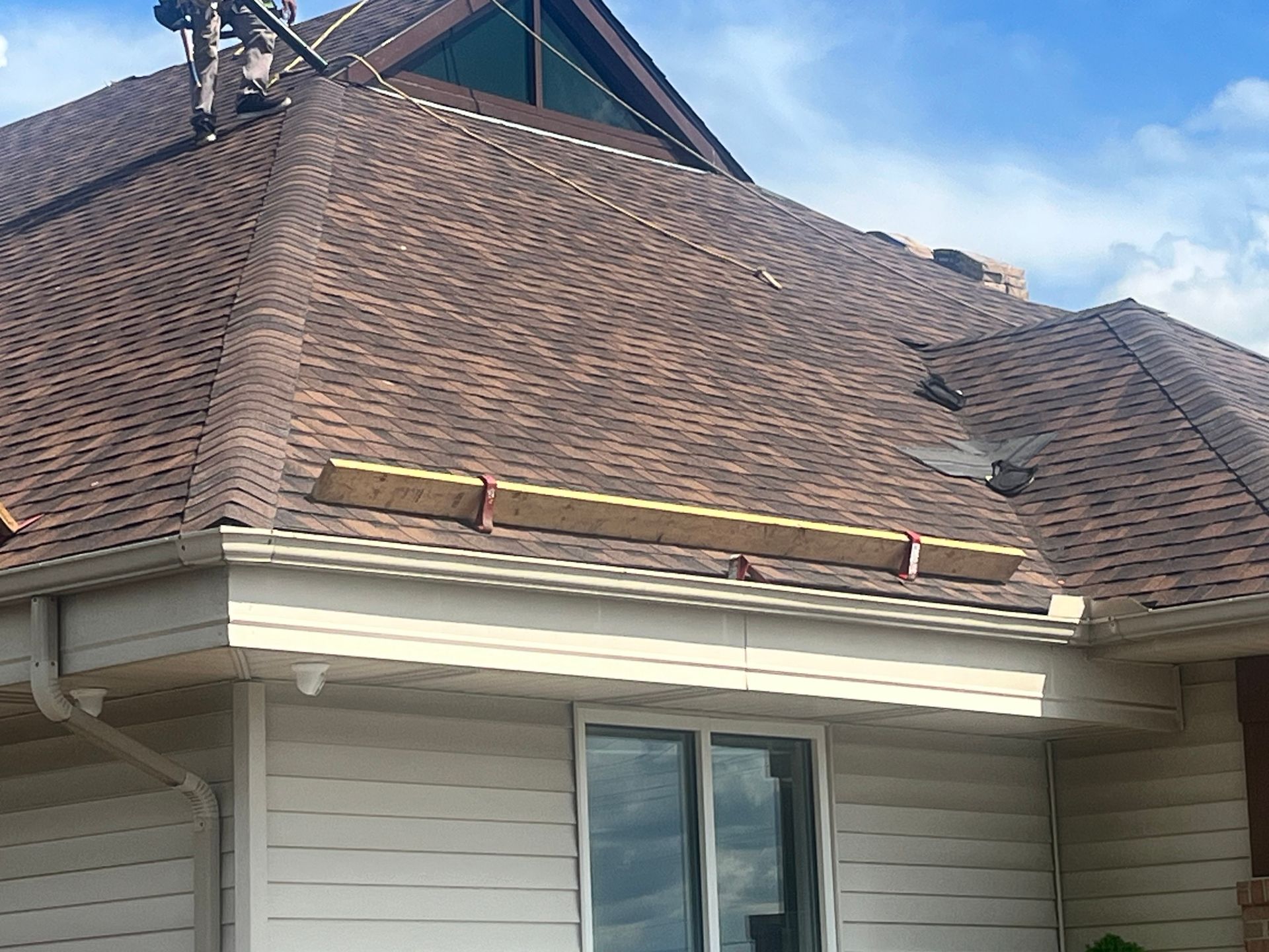 A house with a roof that is being worked on.
