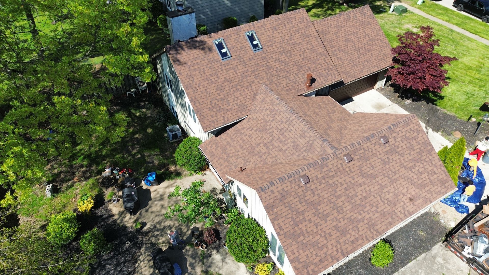 An aerial view of a house with a roof that is being repaired.