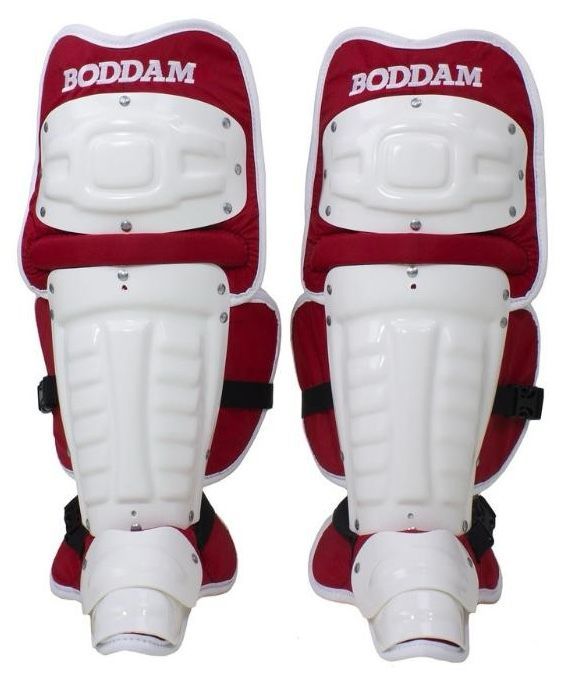 A pair of red and white knee pads with the word boddam on them