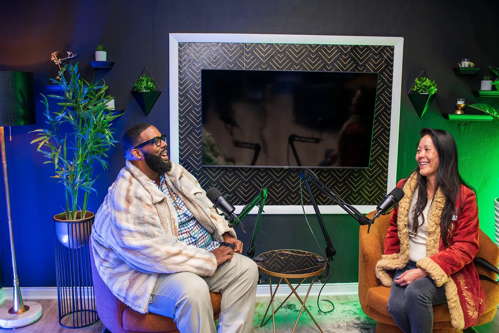 A man presents to a group in an office setting. He gestures towards a whiteboard with notes as others listen.