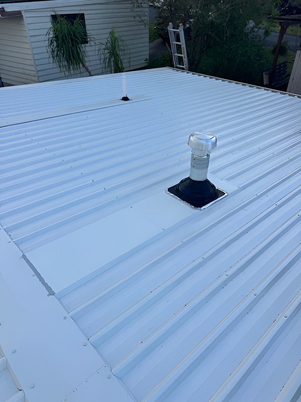White metal roof with ventilation pipes. — Lee Pakau Roofing & Guttering in Banora Point, NSW