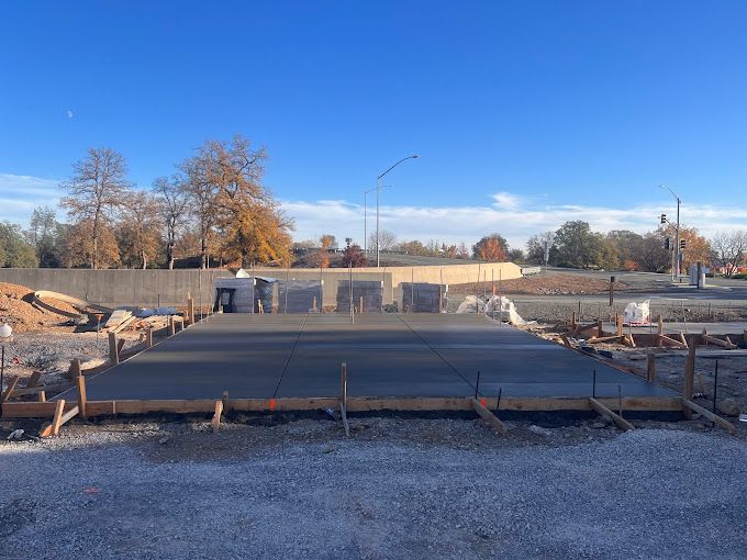 A large concrete slab is being built on a construction site.