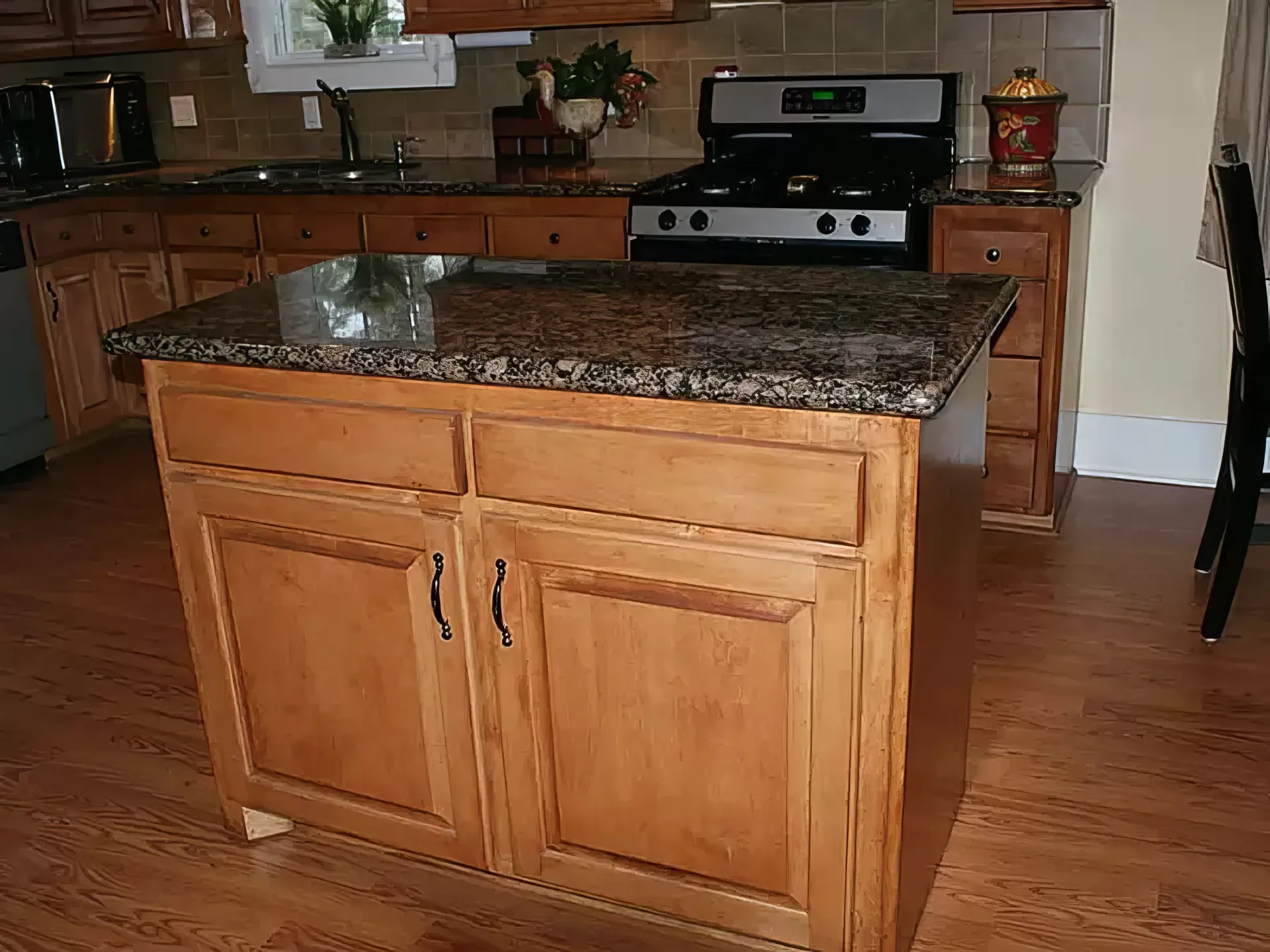 A kitchen with wooden cabinets and granite counter tops