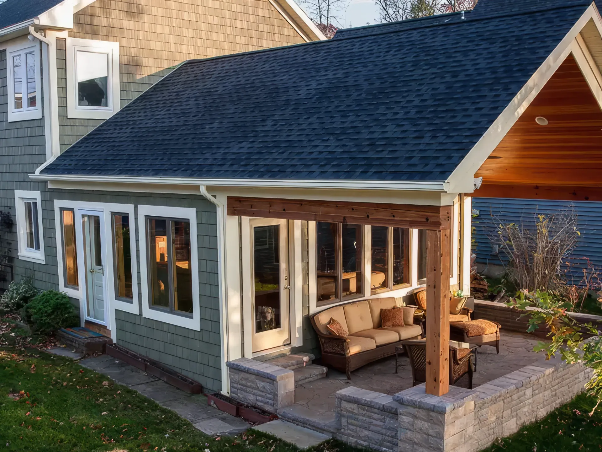 A house with a porch and a couch in front of it.