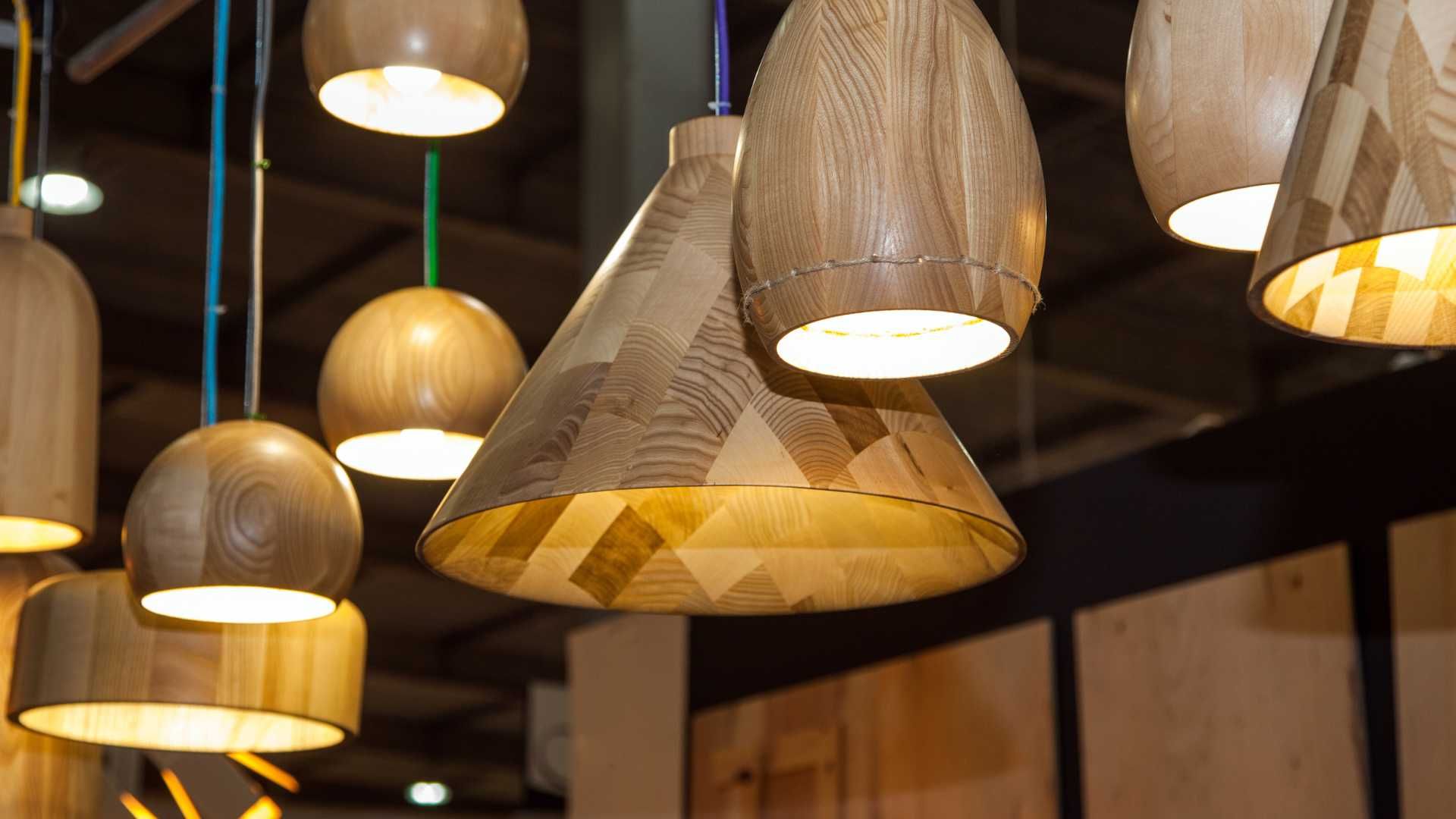 A bunch of wooden pendant lights are hanging from the ceiling.