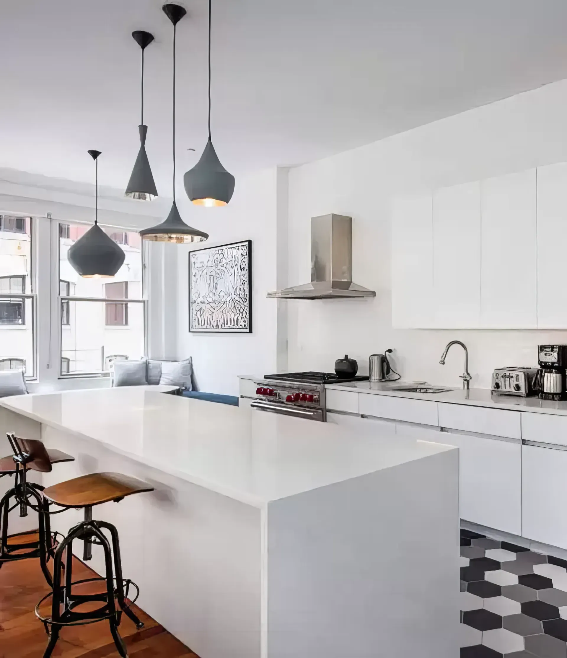 A kitchen with white cabinets and a stove top oven