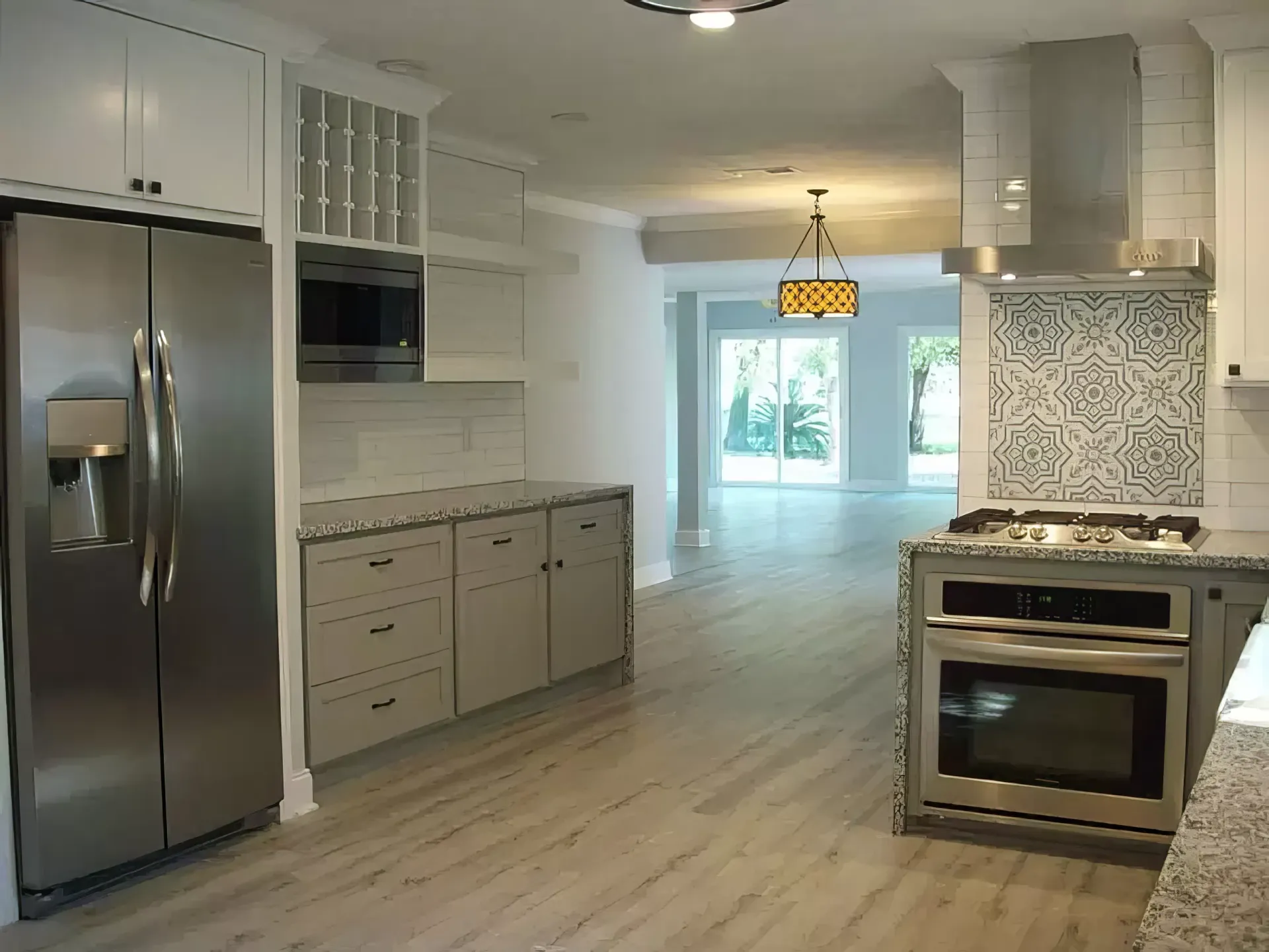 A kitchen with stainless steel appliances and white cabinets