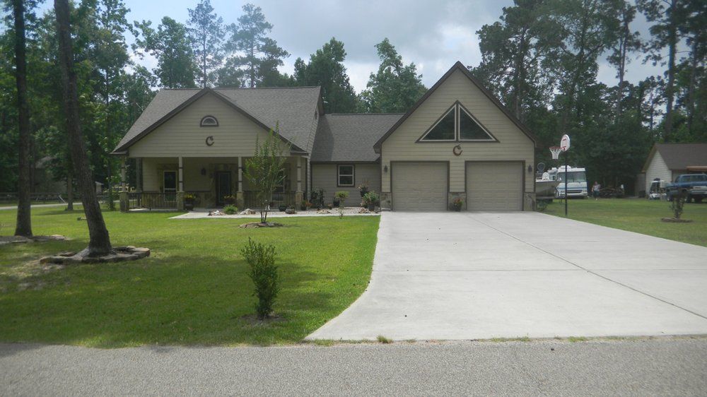 A house with a concrete driveway leading to it