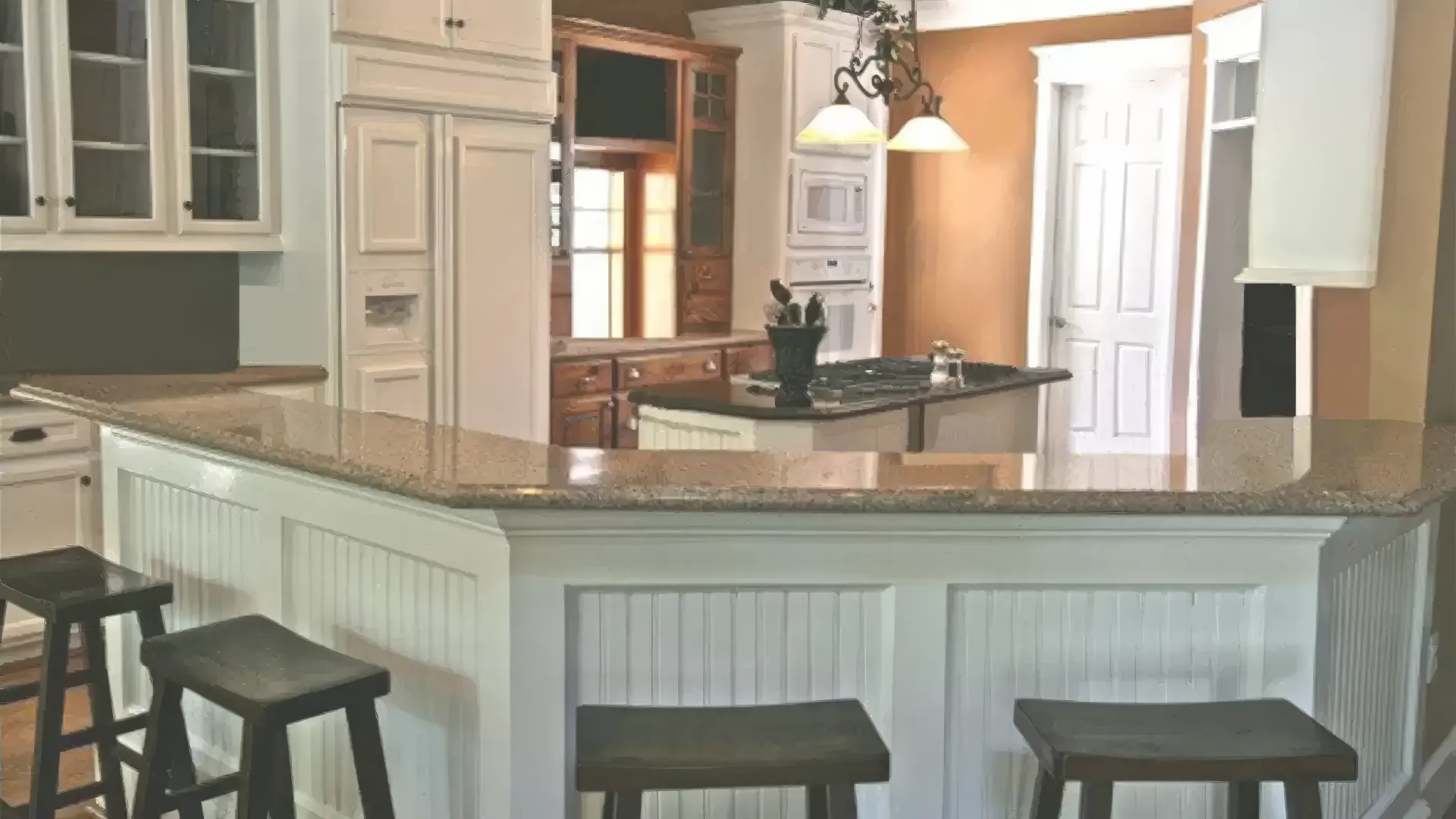 A kitchen with a bar and stools in it