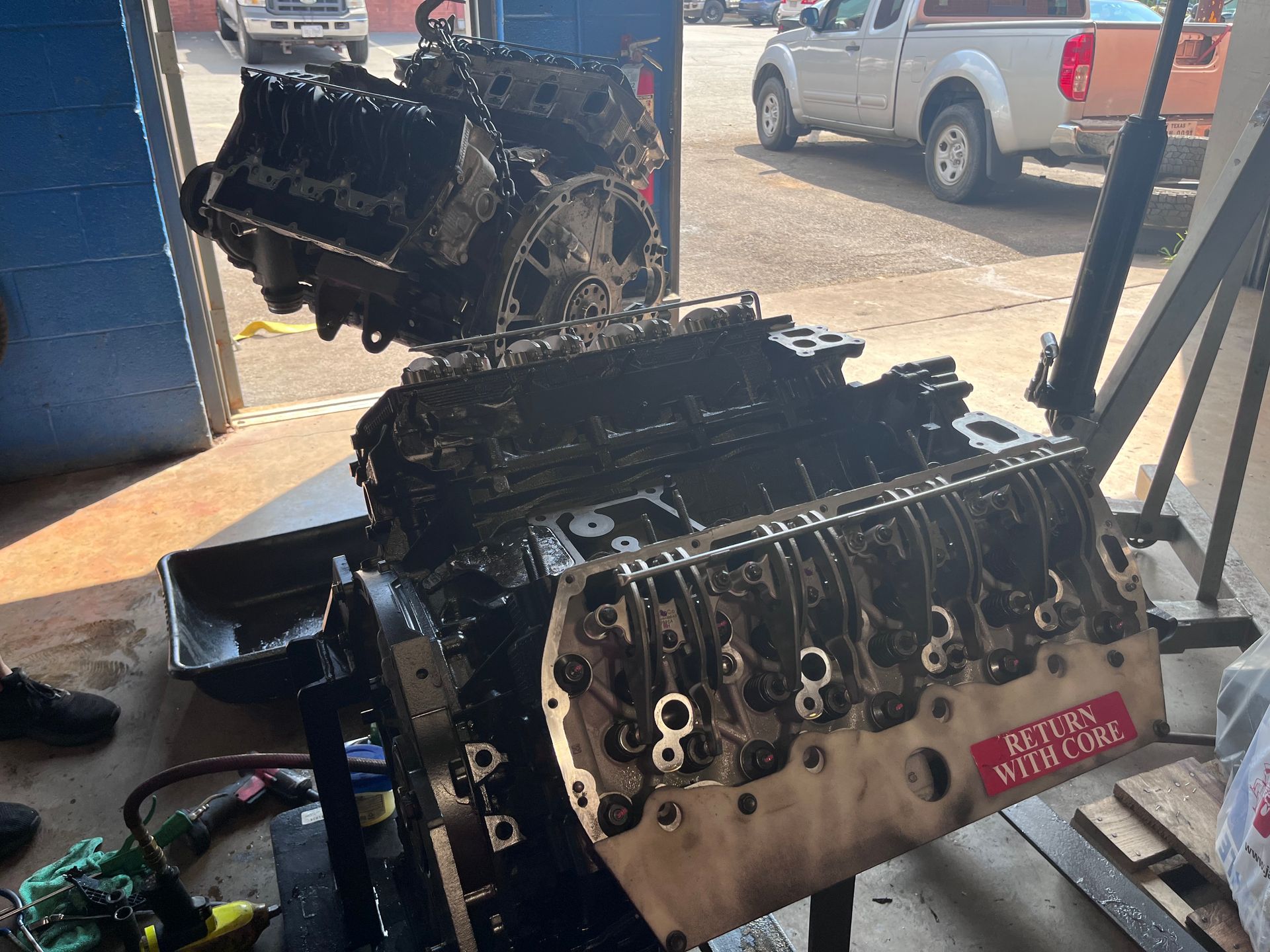 A car engine is being worked on in a garage.