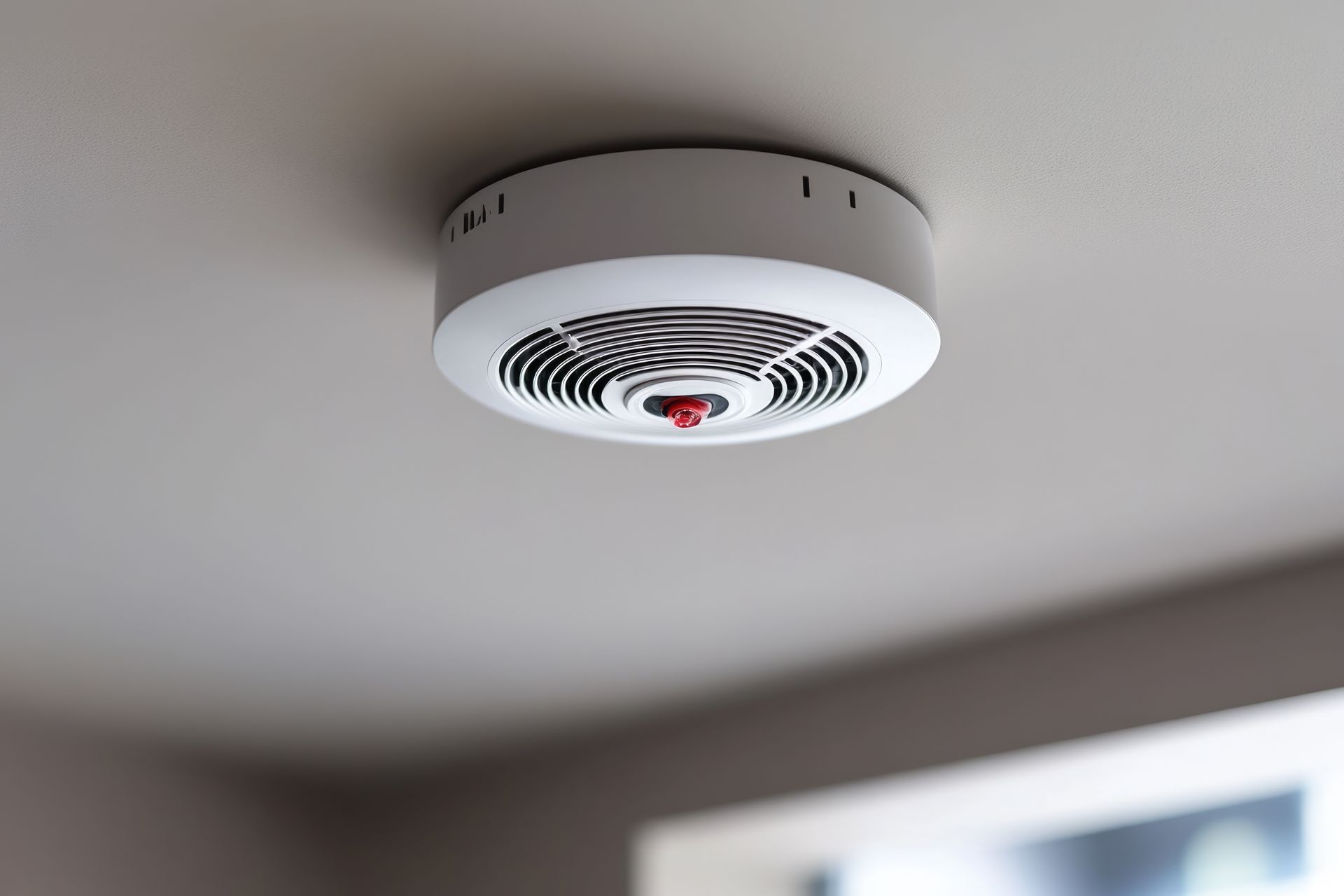 A person wearing blue gloves uses a multimeter to test a circuit breaker panel.