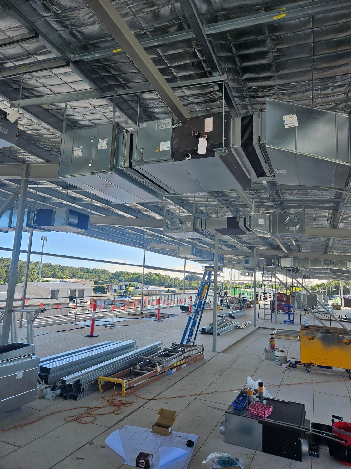 Two Men Are Standing Next To Each Other In Front Of A Refrigerator — Frigid-Air PTY Ltd In Lismore, NSW