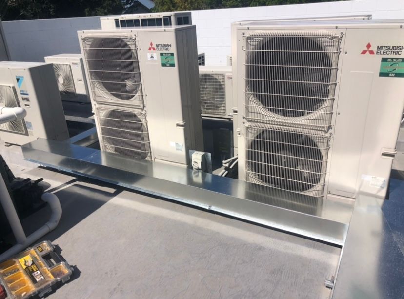 Two Men Are Working On A Machine In A Warehouse — Frigid-Air PTY Ltd In South Lismore, NSW