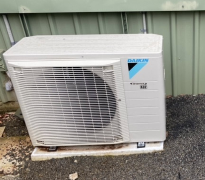 An Air Conditioning Unit Sitting On A Concrete Slab With Dakin Labelled On the Right - Frigid-Air PTY Ltd In South Lismore, NSW