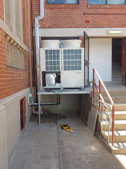 A Large Air Conditioner Is Sitting Outside Of A Brick Building — Frigid-Air PTY Ltd In Alstonville, NSW