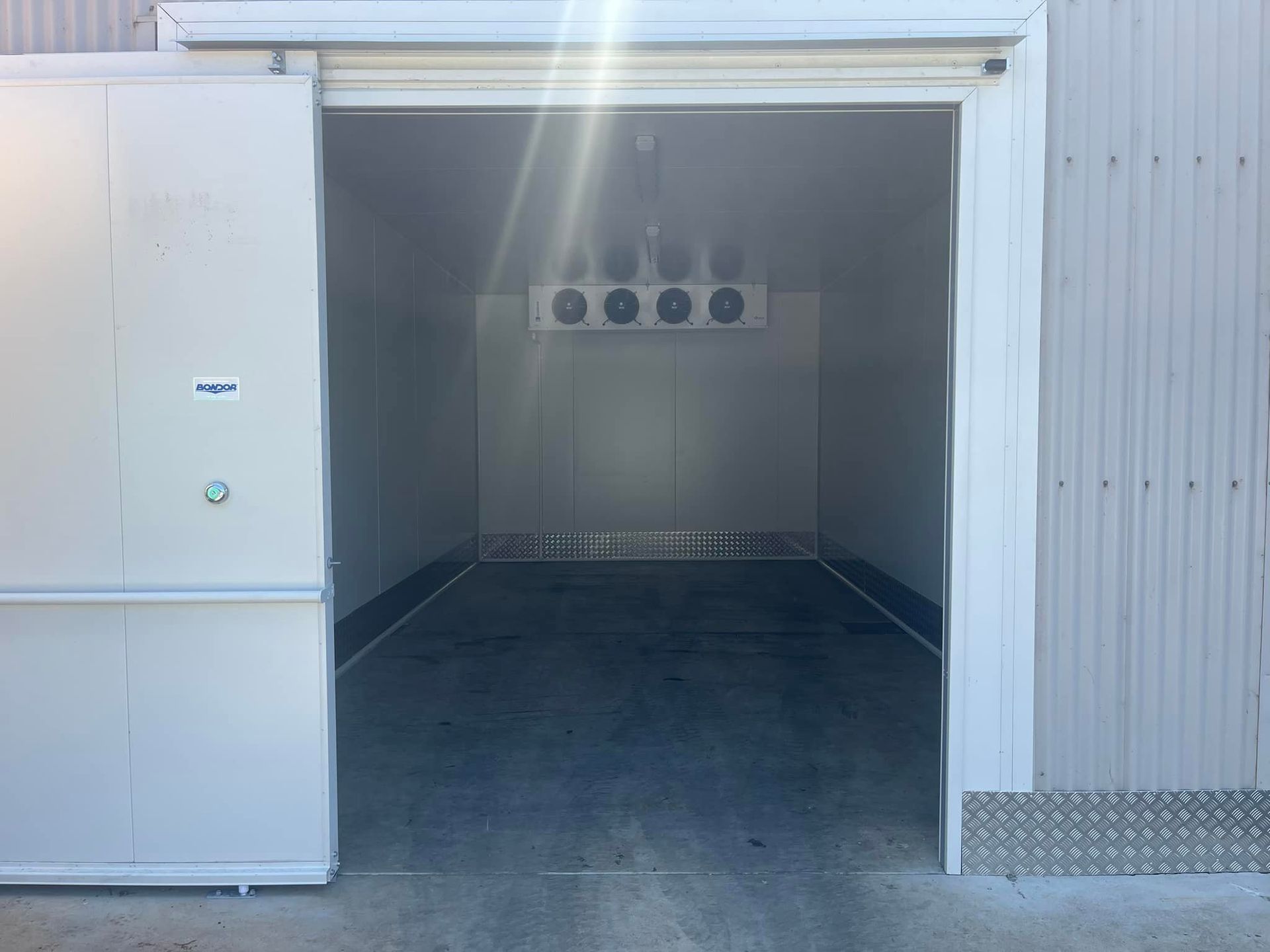A Large Empty Room With A Sliding Door Open — Frigid-Air PTY Ltd In South Lismore, NSW