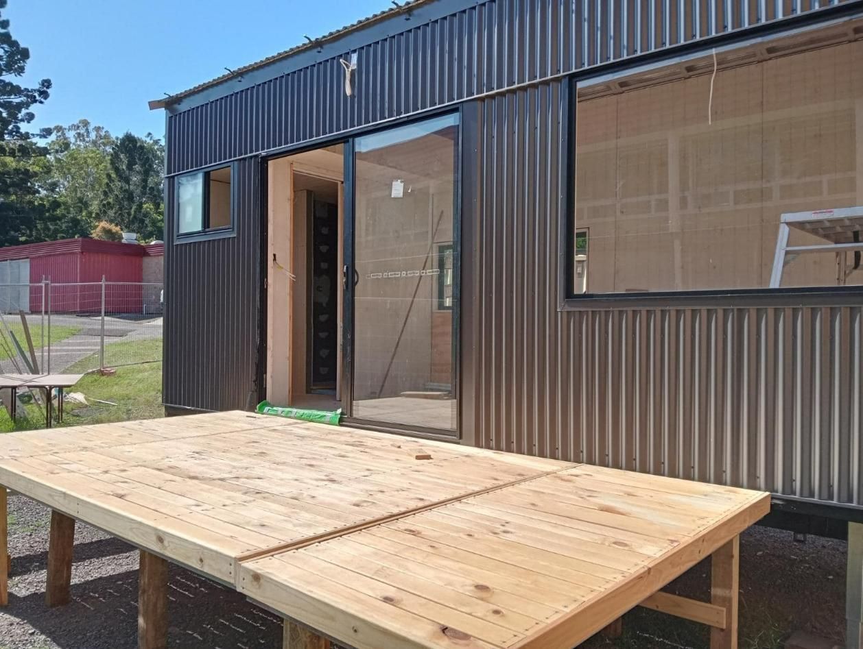 A Wooden Table Is Sitting In Front Of A Building — Frigid-Air PTY Ltd In Evans Head, NSW