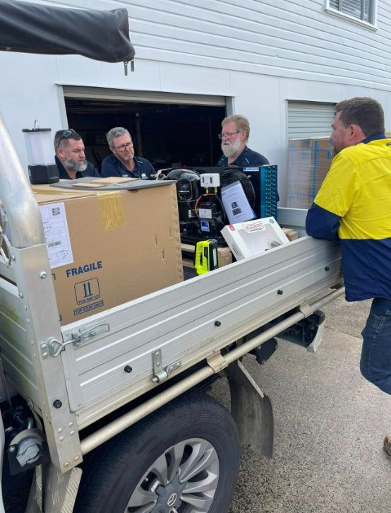 A Man is Loading Boxes Into the Back of a Truck — Frigid-Air PTY Ltd. in South Lismore, NSW