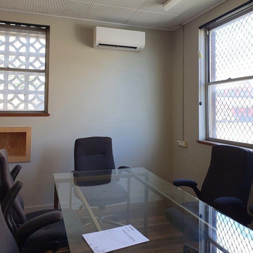 A Conference Room With A Glass Table And Chairs — Frigid-Air PTY Ltd In South Lismore, NSW
