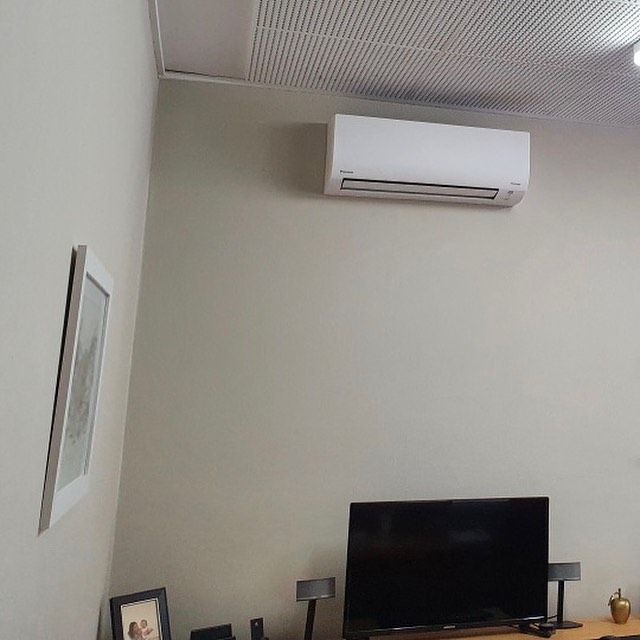 A Living Room With A Flat Screen Tv And Air Conditioner — Frigid-Air PTY Ltd In Ballina, NSW